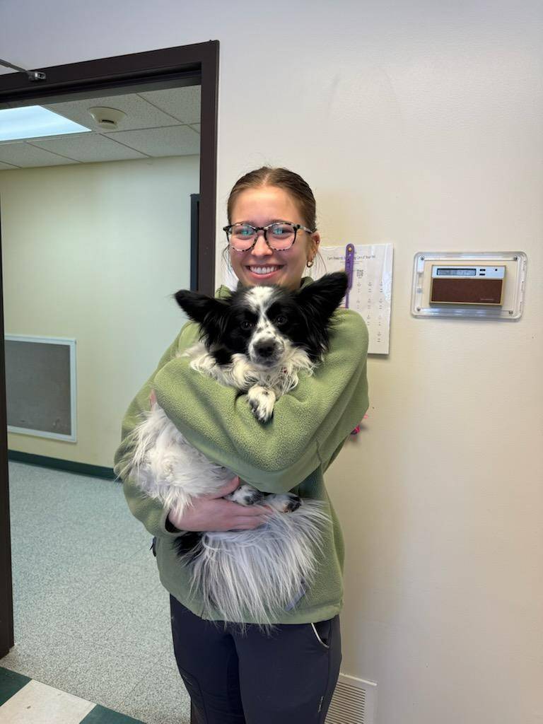 Photo of student, Katherine Darling holding a dog